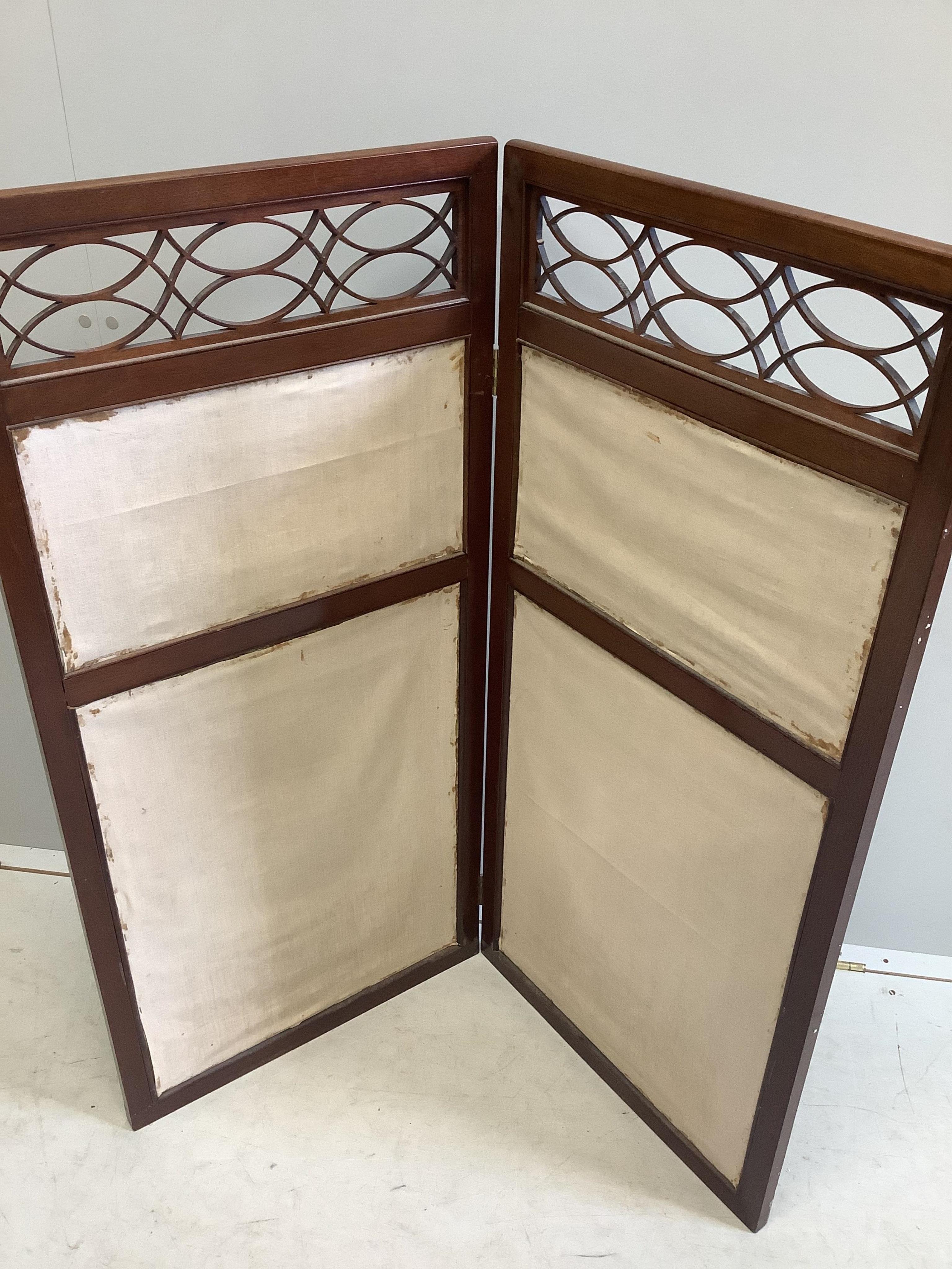 An Edwardian mahogany two fold screen, each panel width 53cm, height 113cm. Condition - fair